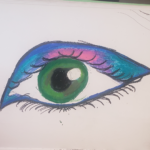 a green colored eye with some blue and pink eyeshadow